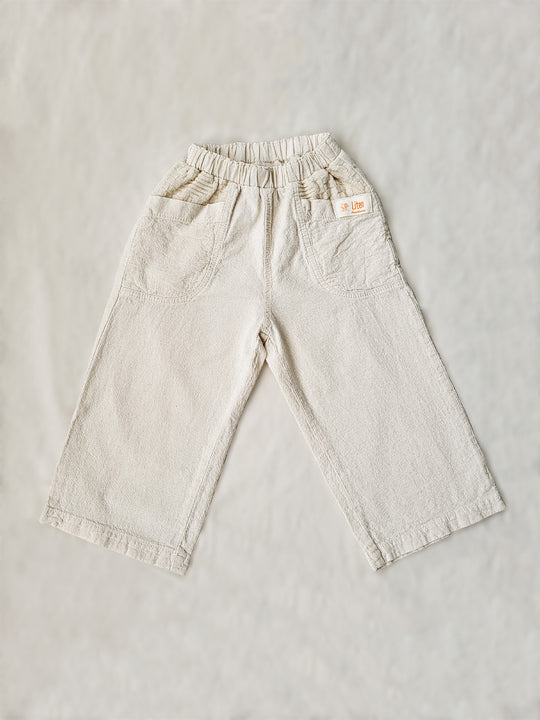 The Olve pants are light and very comfortable. Excellent for traveling or playing outside! These loose-fit pants provide freedom of movement. And the lateral pockets at the front are internally layered with a knitted-cotton pattern. This gives the perfect artisanal touch. Mix and match different outfits with any top from any of our Liten Aventuris collections. Unisex cotton pants. Barnkläder, Bomullskläder, Natural kläder. Flicka, pojken och babis kläder. Barn Byxor.