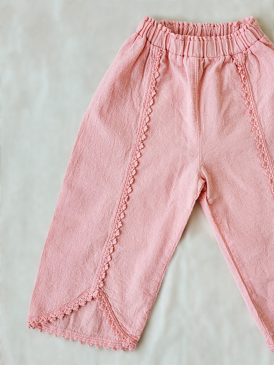 Liten Aventuris Natural Tocuyo Cotton pants for kids. Our Lorin pants are perfect for sunny days. With its loose-fitting size and soft elastic on the waist, toddlers and kids will feel comfortable and free. The Lorin pants bring an embroidered cotton decorative ribbon that will be the perfect match to our Lorin T-shirt! Perfect for girls. Barnkläder, Bomullskläder, Natural kläder. Flicka kläder. Barn Byxor.